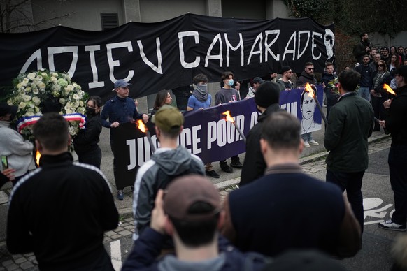 People hold a banner reading 'Goodbye comrade' as they take part in a march in Lyon, France, Saturday, Feb. 21, 2026, to pay tribute to Quentin Deranque, a 23-year-old nationalist activist w ...