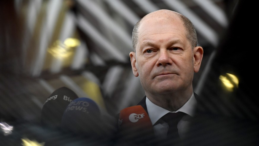 epa09766451 German Chancellor Olaf Scholz speaks with the media as he arrives for an European Union-African Union summit at the European Council building in Brussels, Belgium, 17 February 2022. Europe ...