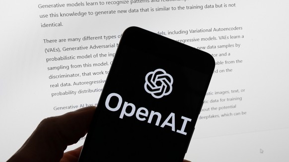 FILE - The OpenAI logo is displayed on a mobile phone in front of a computer screen with output from ChatGPT, March 21, 2023, in Boston. (AP Photo/Michael Dwyer, File)
ChatGPT-Ads