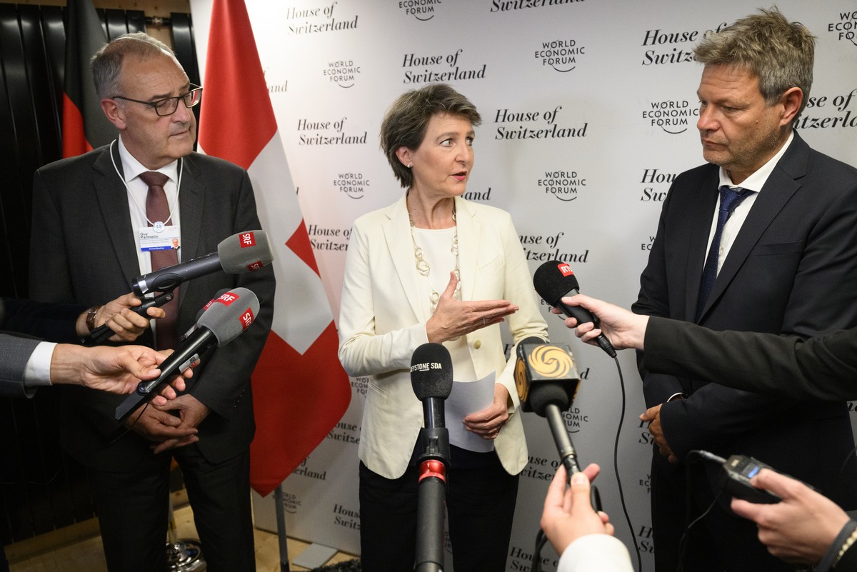 epa09967320 Switzerland's Federal councillor for the environment, transport, energy and communications Simonetta Sommaruga (C) , Switzerland's Federal councillor for economic affairs, Educat ...