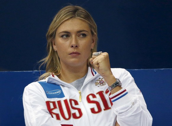 Russia&#039;s Maria Sharapova reacts as she watches compatriot Ekaterina Makarova play against Kiki Bertens of the Netherlands during their Fed Cup World Group tennis match in Moscow, February 6, 2016 ...