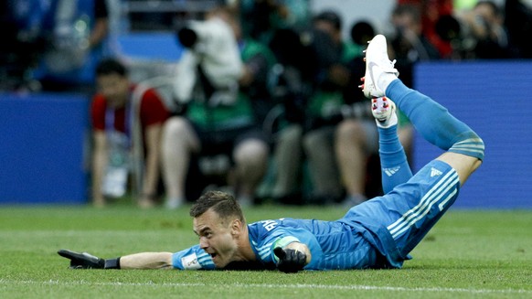 Russia goalkeeper Igor Akinfeev celebrates after saving a penalty during the round of 16 match between Spain and Russia at the 2018 soccer World Cup at the Luzhniki Stadium in Moscow, Russia, Sunday,  ...