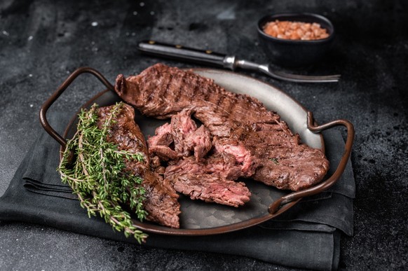 Grilled Beef Machete Skirt Steak, prime meat. black background. top view.