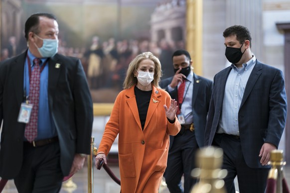 On the eve of the second impeachment trial of former President Donald Trump, Rep. Madeleine Dean, D-Pa., one of the Democratic House impeachment managers, is escorted by security through the Rotunda a ...