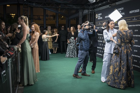 epa12406757 Guests speak to journalists upon arrival on the Green Carpet at the Zurich Film Festival (ZFF) in Zurich, Switzerland, 25 September 2025 (issued 26 September 2025). The 21st edition of the ...