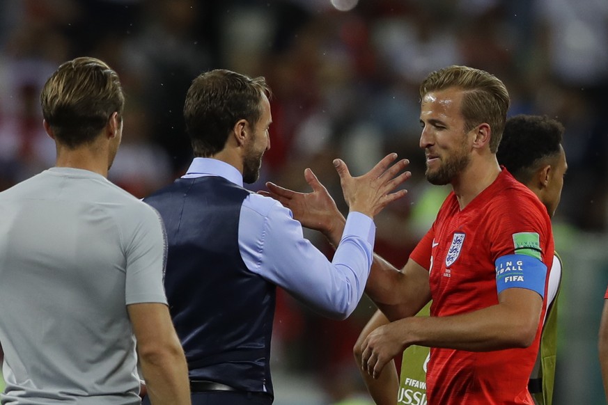 England head coach Gareth Southgate greets Harry Kane after their 2-1 win over Tunisia during a group G match at the 2018 soccer World Cup in the Volgograd Arena in Volgograd, Russia, Monday, June 18, ...