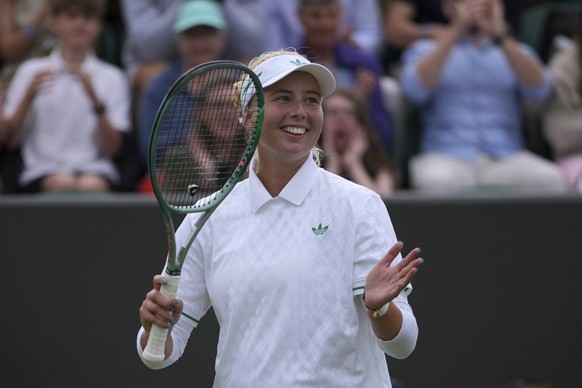 Clara Tauson of Denmark celebrates winning her women&#039;s singles third round match against Elena Rybakina of Kazakhstan at the Wimbledon Tennis Championships in London, Saturday, July 5, 2025.(AP P ...