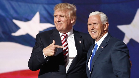 epa08939628 (FILE) Republican Presidential nominee Donald J. Trump (L) embraces Indiana Governor and Republican Vice Presidential nominee Mike Pence (R) during the third day of the 2016 Republican Nat ...