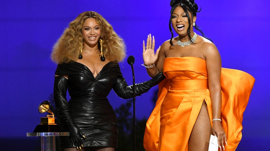 epa09075264 A handout photo made available by The Recording Academy shows Beyonce (R) and Megan Thee Stallion accepting the Best Rap Performance award for &#039;Savage&#039; onstage during the 63rd An ...