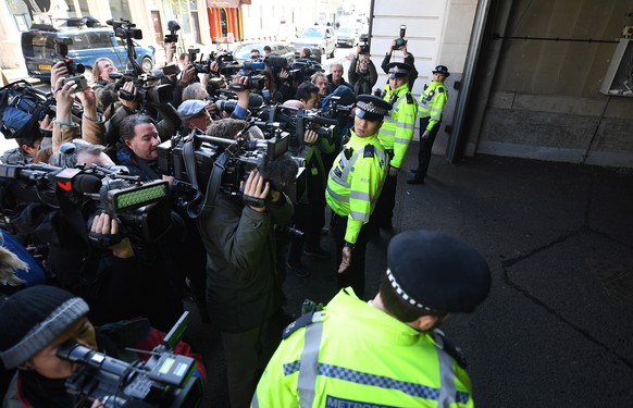 epa07498666 Police hold back the media from a vehicle at Westminster Magistrates Court in London, Britain, 11 April 2019. Wikileaks founder Julian Assange was due to appear before the Westminister Cou ...