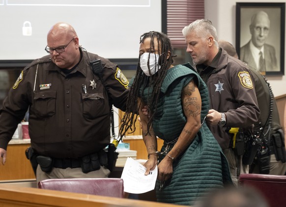 Darrell Brooks, center, is escorted out of the courtroom after making his initial appearance, Tuesday, Nov. 23, 2021 in Waukesha County Court in Waukesha, Wis. Prosecutors in Wisconsin have charged Br ...