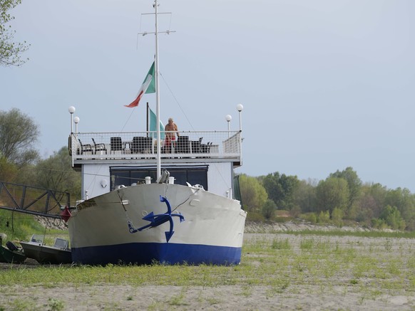 A boat restaurant lies on the dried riverbed at a tourist dock along the Po river in Ficarolo, Italy, Thursday, July 28, 2022. Italy&#039;s drought has dried up rivers crucial for irrigation threateni ...