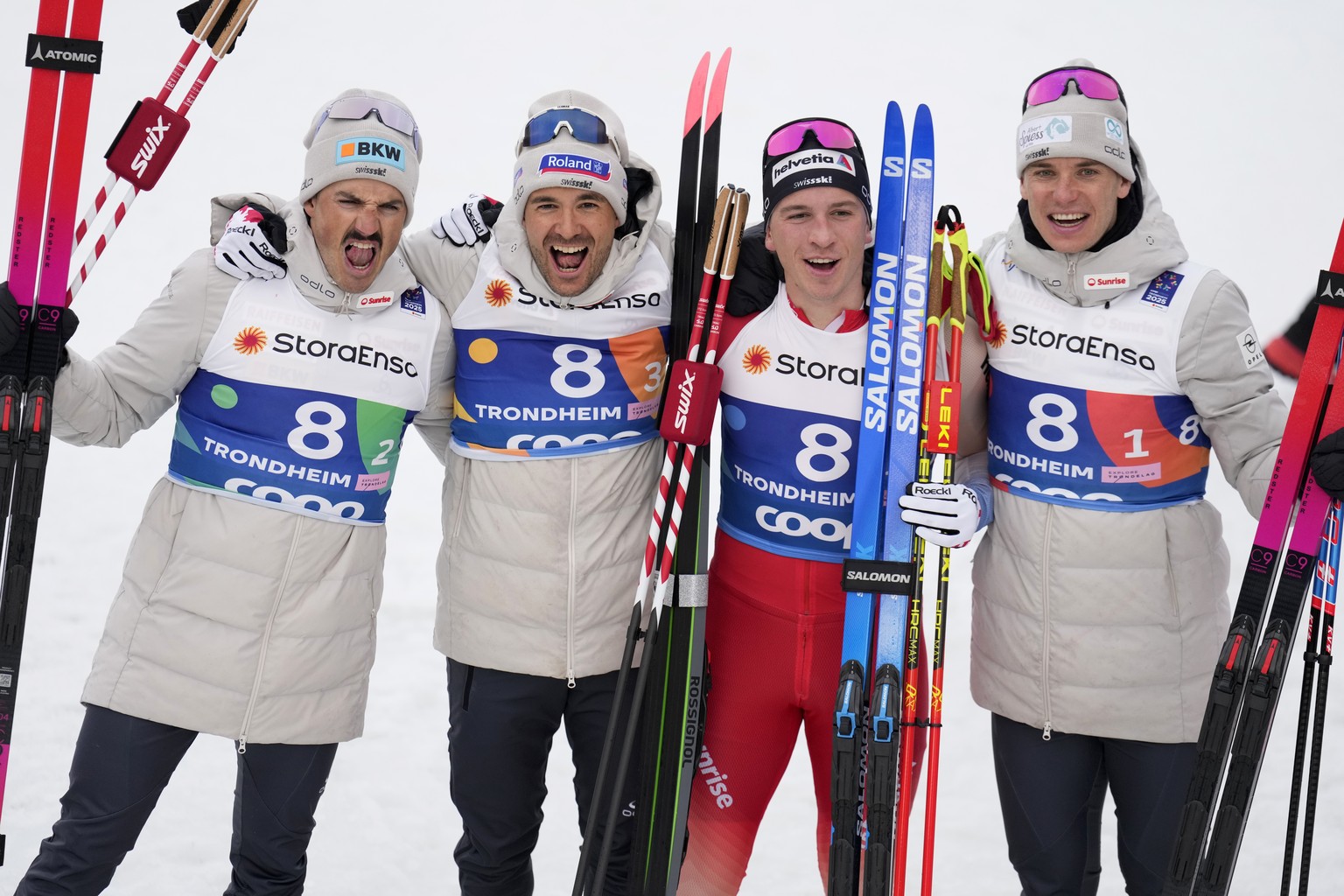 Jonas Baumann, Jason Rueesch, Valerio Grond, and Cyril Faehndrich, from left, of Switzerland, celebrate after winning the silver medal in the cross-country men&#039;s relay 4X7.5 Km at the Nordic Worl ...