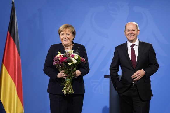 New elected German Chancellor Olaf Scholz, right, and former Chancellor Angela Merkel laughs together during a handover ceremony in the chancellery in Berlin, Wednesday, Dec. 8, 2021. (Photo/Markus Sc ...