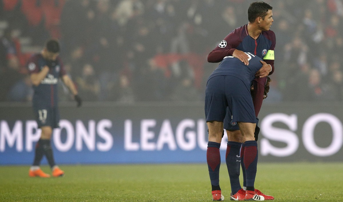 Captain PSG's Thiago Silva, right, hugs PSG's Adrien Rabiot after the Champions League round of sixteen second leg soccer match between Paris St. Germain and Real Madrid at the Parc des Prin ...