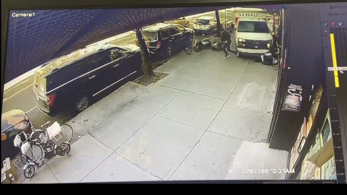 In this photo taken from security video, a man jumps out of the way as a U-Haul truck drives onto the sidewalk, Monday, Feb. 13, 2023, in the Brooklyn borough of New York. Authorities say a man drivin ...