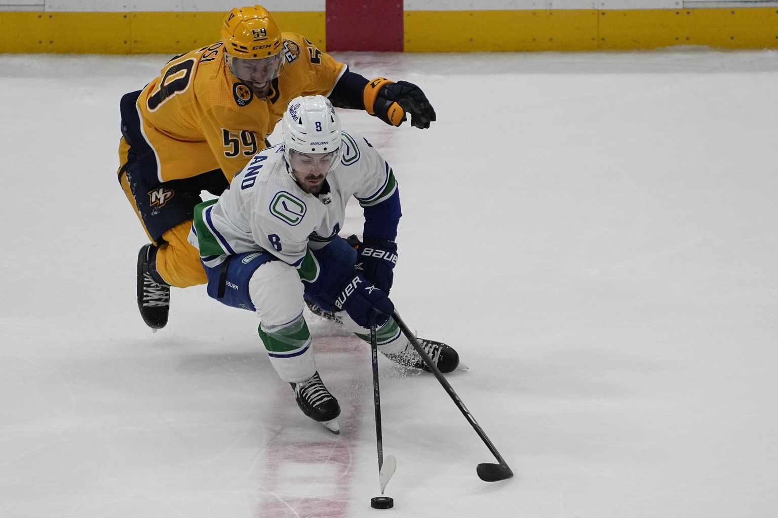 Vancouver Canucks right wing Conor Garland (8) skates the puck past Nashville Predators defenseman Roman Josi (59) during the third period of an NHL hockey game Tuesday, Oct. 24, 2023, in Nashville, T ...