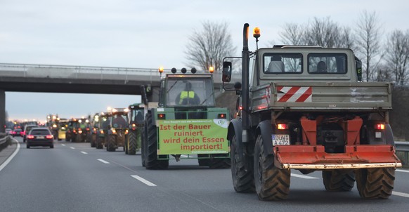 epa11064094 Farmers with their tractors drive on the Highway A65 during a nationwide farmers&#039; strike near Neustadt an der Weinstrasse, Germany, 08 January 2024. Farmers went on strike nationwide  ...