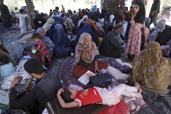 Internally displaced Afghans from northern provinces, who fled their home due to fighting between the Taliban and Afghan security personnel, take refuge in a public park in Kabul, Afghanistan, Tuesday ...