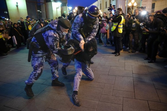 Riot police detain a demonstrator during a protest against mobilization in Moscow, Russia, Wednesday, Sept. 21, 2022. Russian President Vladimir Putin has ordered a partial mobilization of reservists  ...