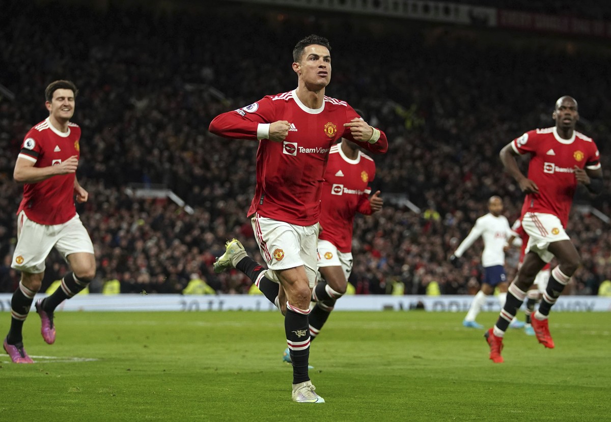 Manchester United's Cristiano Ronaldo, center, celebrates after scoring his third goal during the English Premier League soccer match between Manchester United and Tottenham Hotspur, at the Old T ...
