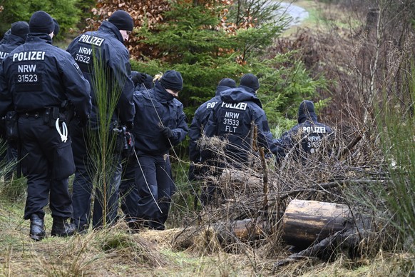 14.03.2023, Nordrhein-Westfalen, Freudenberg: Polizisten suchen am Fundort des get