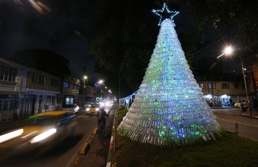 A christmas tree made of recycled materials decorates a street in Bogota, Colombia, Tuesday, Dec. 13, 2022. (AP Photo/Fernando Vergara)