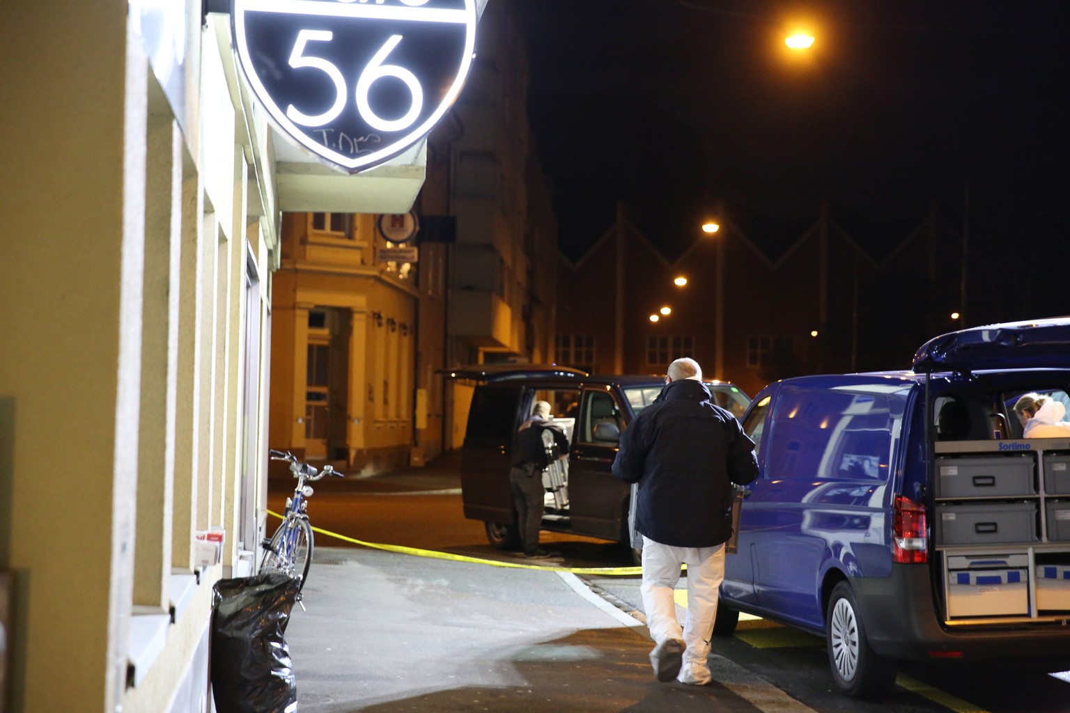 A forensic team investigates the scene after deadly gunfire was unleashed in Cafe 56, Friday, March 10, 2017, in Basel, Switzerland. (AP Photo/Dominique Soguel)