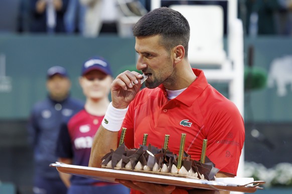 Serbia&#039;s Novak Djokovic tastes his birthday cake after he won the men&#039;s singles second round of the ATP 250 Geneva Open tournament in Geneva, Switzerland, Wednesday, May 22, 2024. (KEYSTONE/ ...