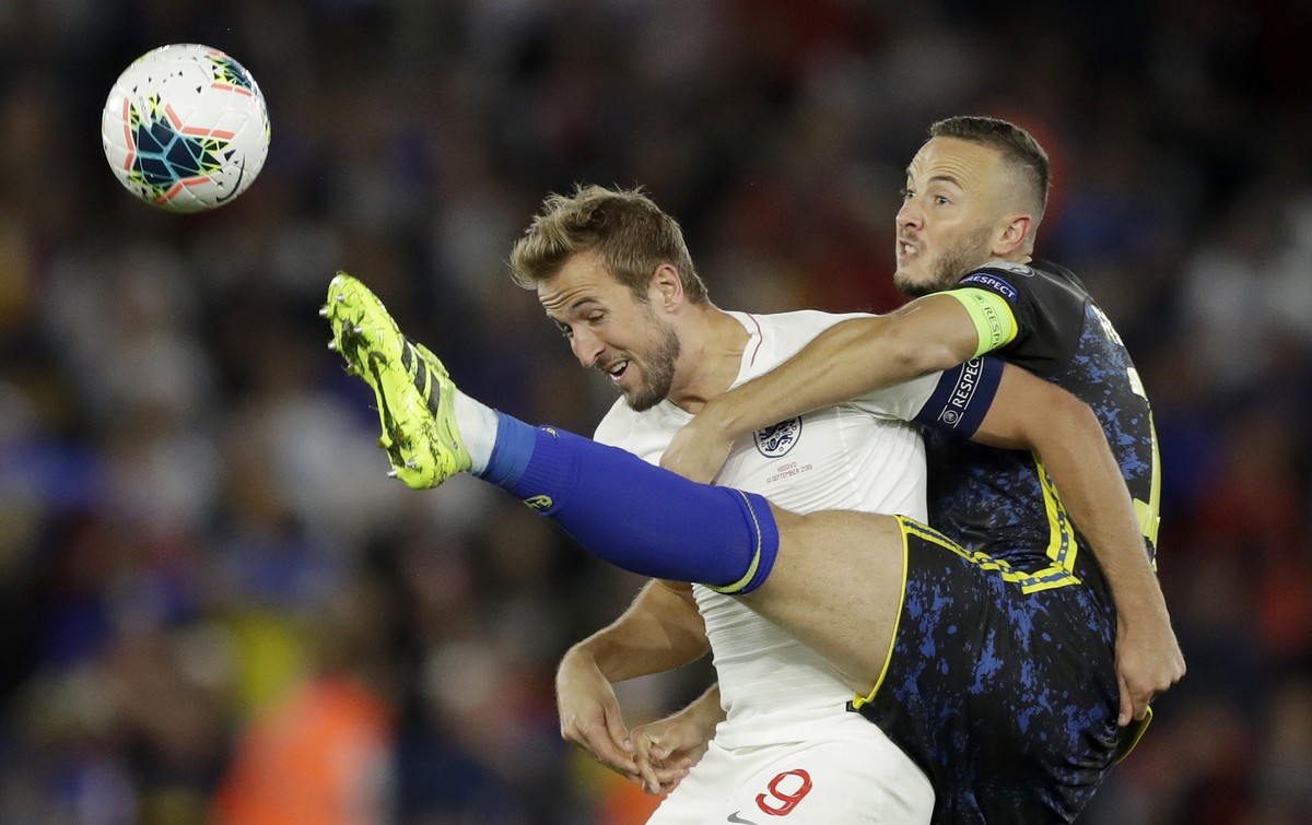 England's Harry Kane, left, and Kosovo's Amir Rrahmani challenge for the ball during the Euro 2020 group A qualifying soccer match between England and Kosovo at St Mary's Stadium in Sou ...
