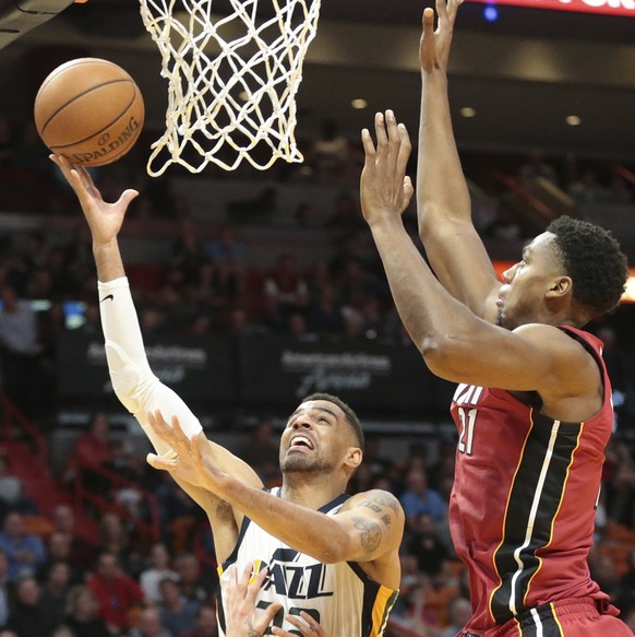 Miami Heat center Hassan Whiteside (21) and guard Tyler Johnson (8) defend against Utah Jazz forward Thabo Sefolosha (22) who drives to the basket during the second half of an NBA basketball game, Sun ...