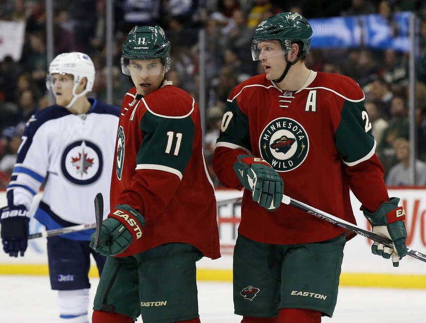 FILE- In this Nov. 27, 2015, file photo, Minnesota Wild left wing Zach Parise (11) talks with defenseman Ryan Suter (20) during the second period of an NHL hockey game against the Winnipeg Jets in St. ...