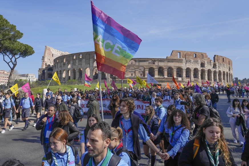 Demonstrators hold a banner reading: &quot;Rome free city&quot; as they walk past the Colosseum in Rome, Italy, Thursday, March 21, 2024 during a march to honor the over 1,000 people killed in Italy b ...
