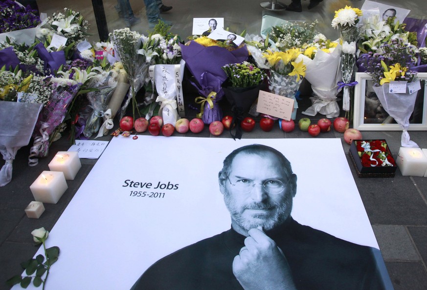 Fresh apples, flowers and a large poster of Steve Jobs are placed outside an Apple retail store in Beijing, China, Thursday, Oct. 6, 2011. Steve Jobs, the co-founder of Apple Inc. and father of the iP ...