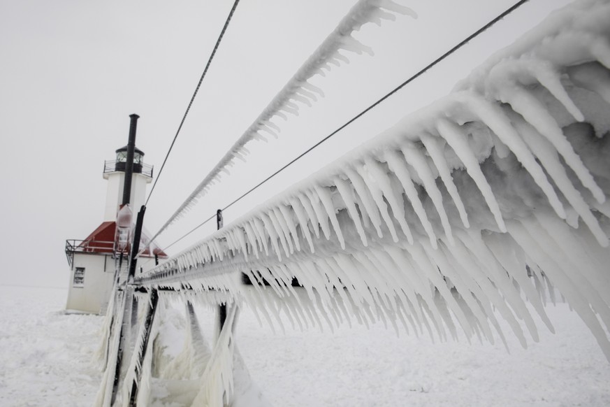 Ice covers the St Joseph North Pier catwalk in St. Joseph, Mich., on Thursday, Jan. 31, 2019. The National Weather Service recorded wind chill index of minus 20 degrees throughout most of Thursday. (J ...