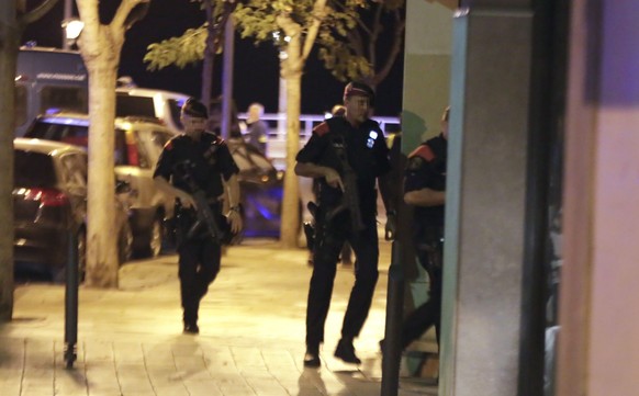 epa06149329 Spanish Policemen inspect a street in Cambrils (Tarragona), northeastern Spain, 18 August 2017, where at least four suspected terrorists have been killed by the police after they knocked d ...