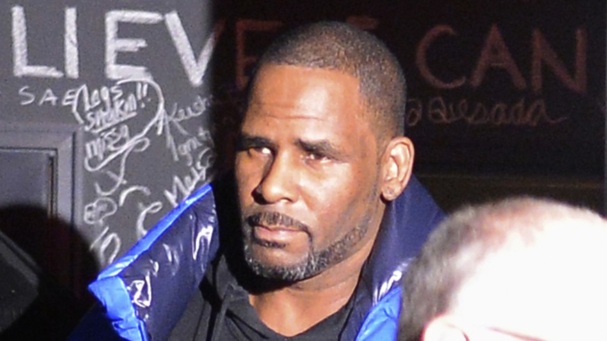 Musician R. Kelly leaves his Chicago studio Friday night, Feb. 22, 2019, on his way to surrender to police. R&amp;B star Kelly was taken into custody after arriving Friday night at a Chicago police pr ...