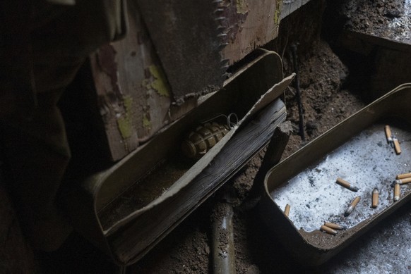 A grenade lies in a box in the trench at the Ukrainian frontline positions near Zolote, Ukraine, Monday, Feb. 7, 2022. (AP Photo/Mstyslav Chernov)