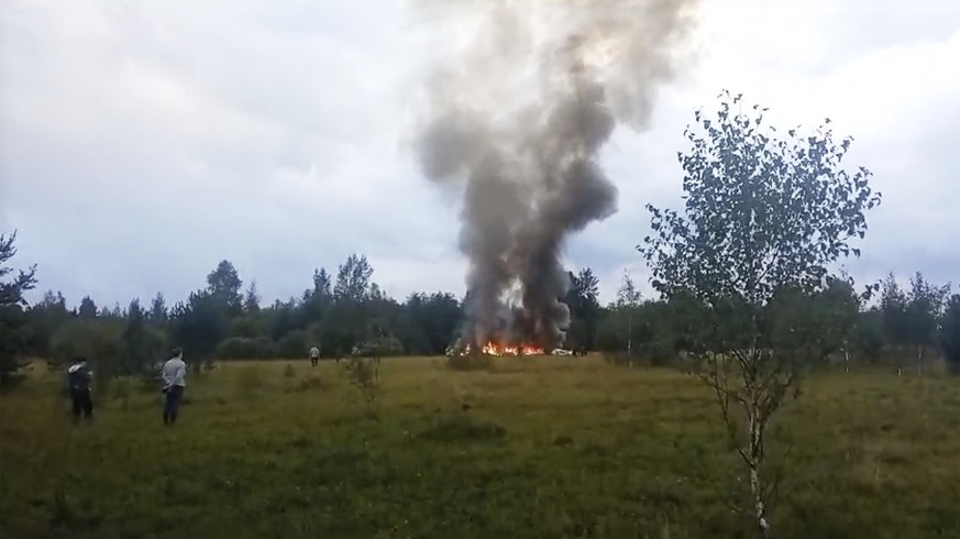 In this image taken from video, smoke and flames rise from a crashed private jet near the village of Kuzhenkino, Tver region, Russia, Wednesday, Aug. 23, 2023. Russian mercenary leader Yevgeny V. Prig ...