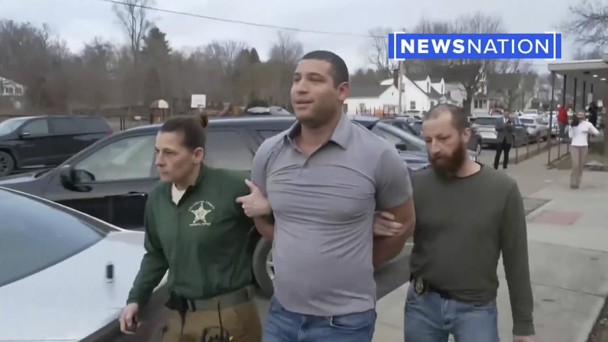 This image taken from video provided by Newsnation/TMX shows reporter Evan Lambert being taken into police custody on Wednesday, Feb. 8, 2023 in East Palestine, Ohio. NewsNation posted video of their  ...