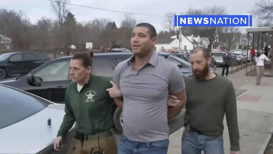 This image from a Newsnation/TMX video shows reporter Evan Lambert being taken into police custody in East Palestine, Ohio on Wednesday, February 8, 2023.  NewsNation posted a video of their…