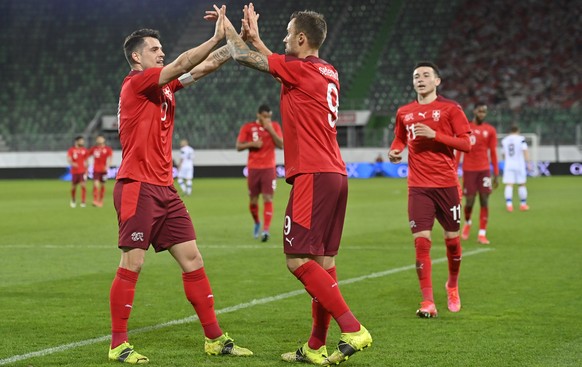 epa09109522 Switzerland's Haris Seferovic (C) celebrates with teammate Granit Xhaka (L) after scoring the 3-2 lead during the International Friendly soccer match between Switzerland and Finland i ...