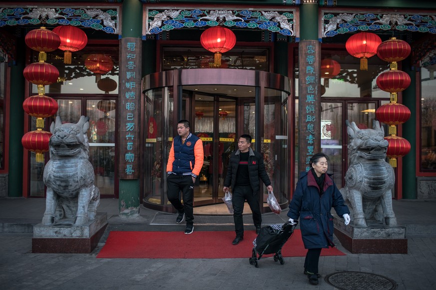 epa07337506 Chinese people leave a Peking duck restaurant in Beijing, China, 01 February 2019 (issued 02 February 2019). The Chinese Lunar New Year, or Spring Festival, is a festive season full of fea ...
