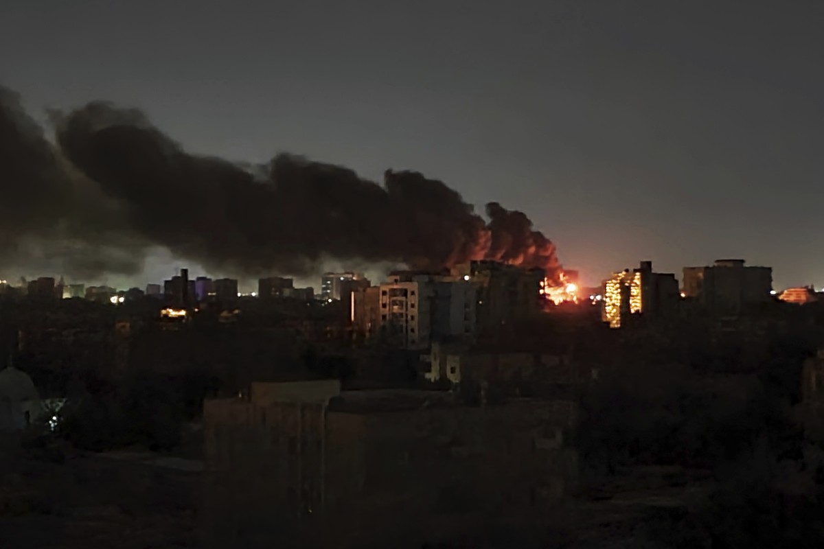 Smoke rises over the horizon as a fire burns after a strike in Khartoum, Sudan, Sunday, April 16, 2023. Washington's top diplomat said Tuesday, April 18, 2023, that a U.S. Embassy convoy came und ...
