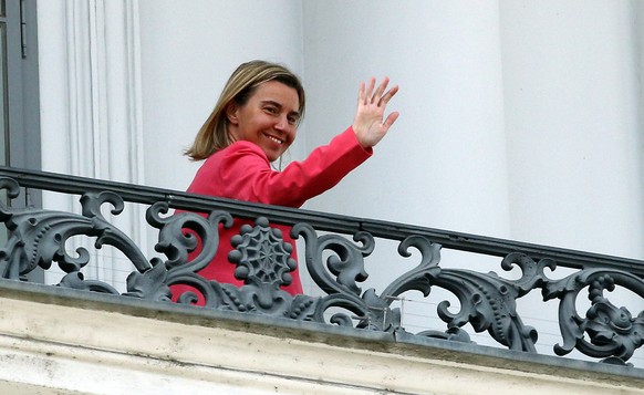 European Union High Representative Federica Mogherini waves from a balcony of the Palais Coburg where closed-door nuclear talks with Iran continue in Vienna, Austria, Monday, July 13, 2015. (AP Photo/ ...