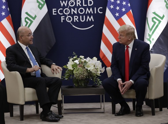 US President Donald Trump, right, attends a meeting with his Iraqi counterpart Barham Salih at the World Economic Forum in Davos, Switzerland, Wednesday, Jan. 22, 2020. Trump&#039;s two-day stay in Da ...