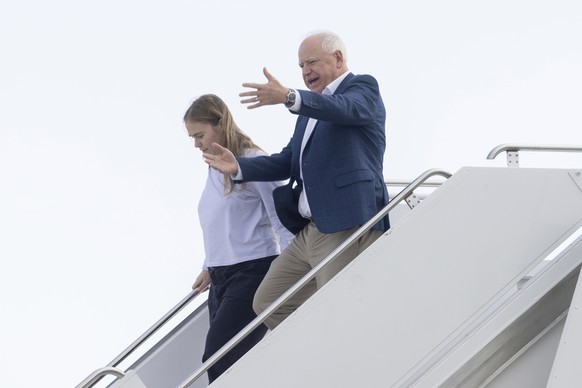 Democratic vice presidential nominee Minnesota Gov. Tim Walz, right, and his daughter Hope arrive at Eppley Airfield, Saturday, Oct. 19, 2024, in Omaha, Neb. (Chris Machian/Omaha World-Herald via AP)