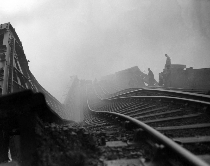 A view of the twisted viaduct, looking like a switch-back railway, which collapsed on a train crash at Lewisham, London , on December 4, 1957. Firemen and rescue workers had toiled through the night t ...