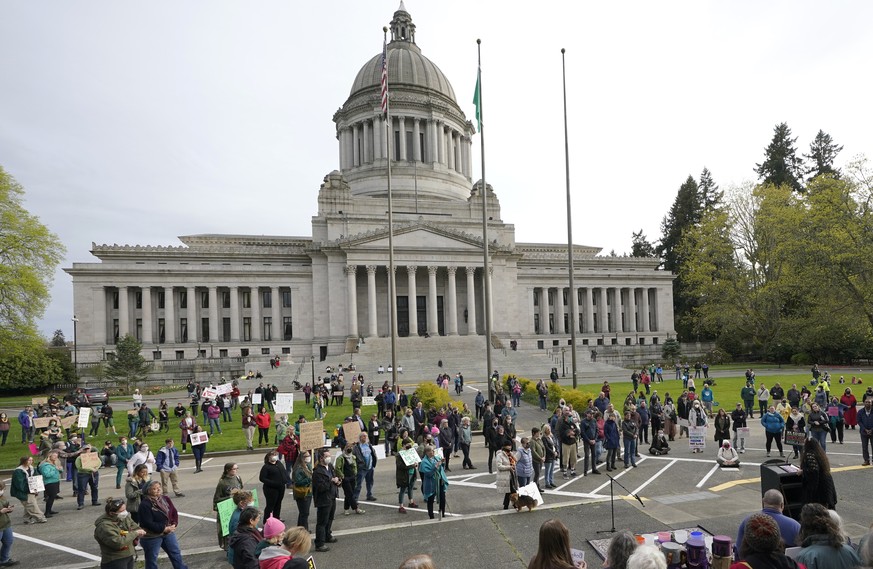 People demonstrating in favor of abortion rights gather during an evening rally, Tuesday, May 3, 2022, at the Capitol in Olympia, Wash. (AP Photo/Ted S. Warren)