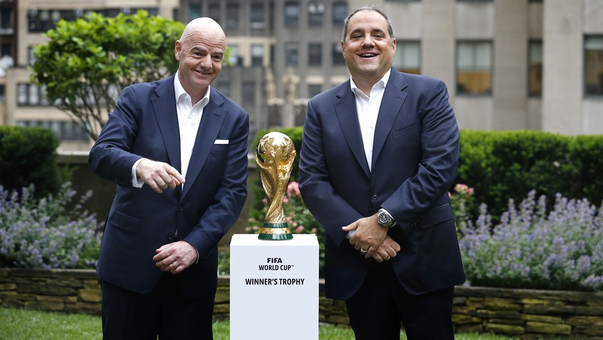 FIFA President Gianni Infantino, left, and Vice President Vittorio Montagliani stand with the FIFA World Cup trophy. Thursday, June 16, 2022, in New York. (AP Photo/Noah K. Murray)